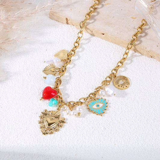 Collier chaîne dorée avec breloques ex voto et œil