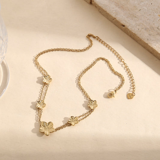 Collier choker doré double chaîne fine orné de fleurs
