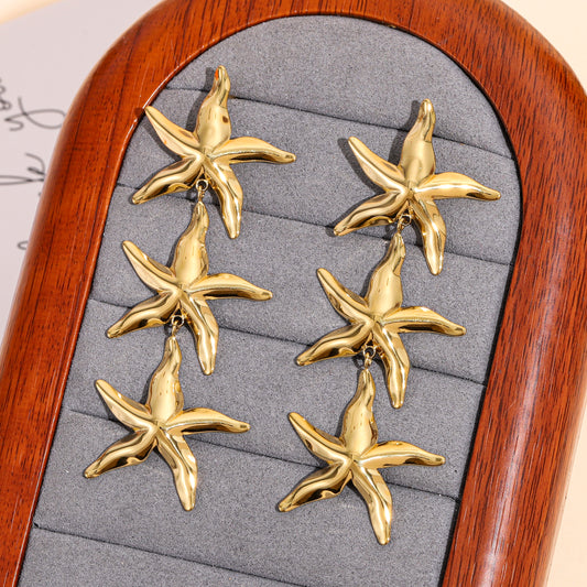 Boucles d'oreilles dorées trois étoiles de mer effet miroir