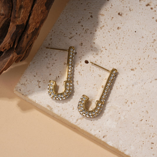 Boucles d'oreilles dorées forme J en strass