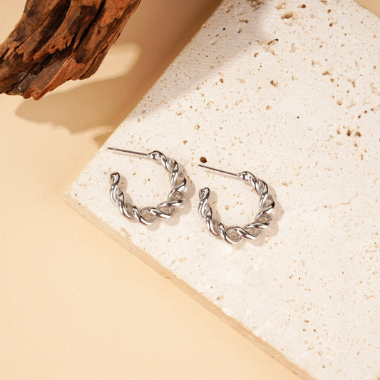 Boucles d'oreilles créoles dorées torsadées effet tressé