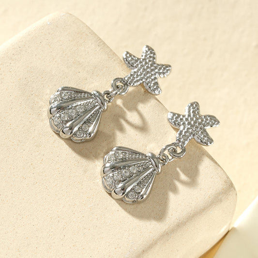 Boucles d'oreilles étoile de mer et coquillage strassé