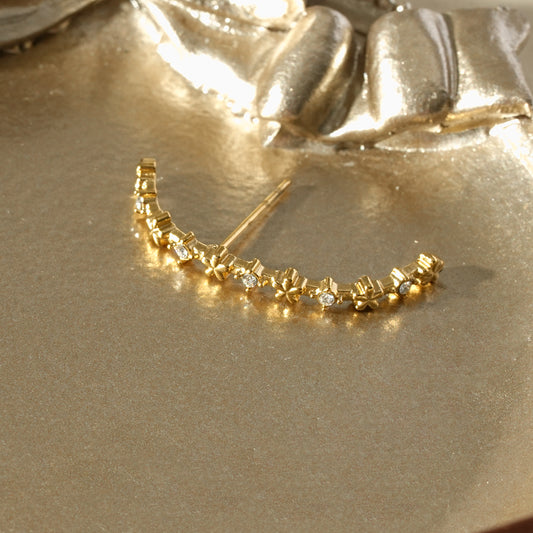 Boucle d'oreille unique en arc orné de fleurs et de strass minimalistes