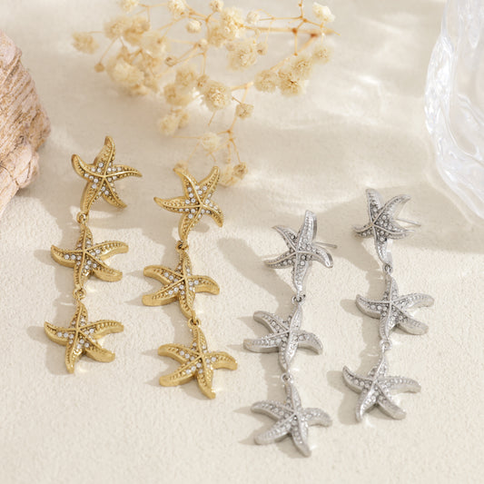 Boucles d'oreilles dorées 3 étoiles de mer strassées