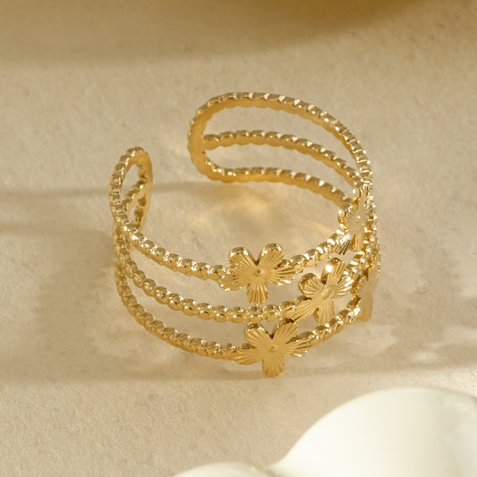Bague dorée ajustable triple anneau ornée de fleurs