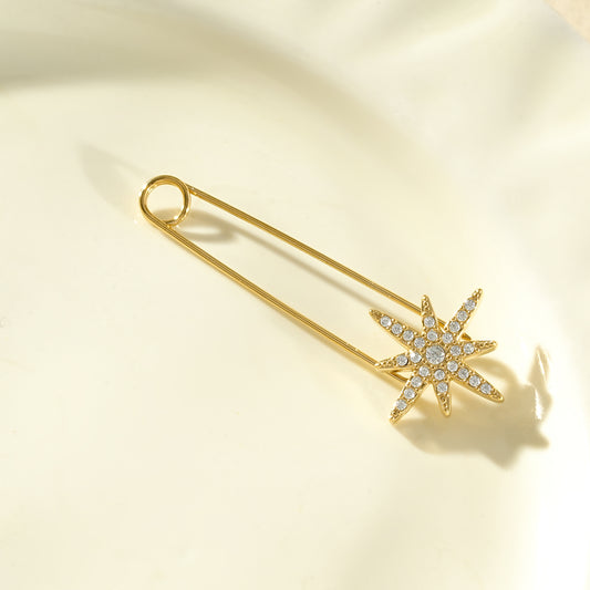 Broche épingle dorée étoile à 8 branches pavée de strass