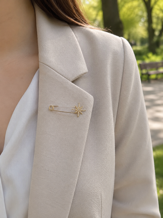 Broche épingle dorée étoile à 8 branches pavée de strass