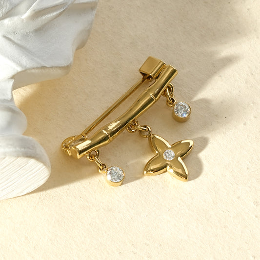 Broche dorée design bambou pendant étoile et strass