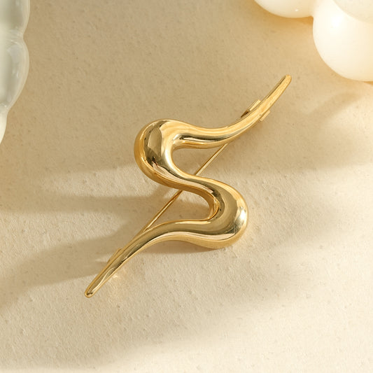 Broche dorée forme vague abstraite