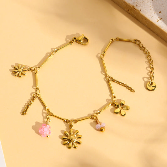 Bracelet doré à charms fleurs marguerites