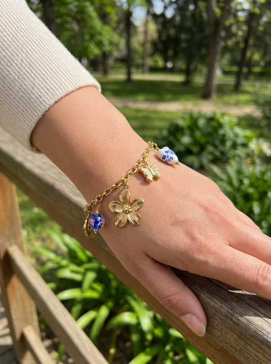 Bracelet doré à charms floraux et breloques en porcelaine