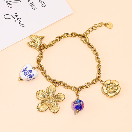 Bracelet doré à charms floraux et breloques en porcelaine