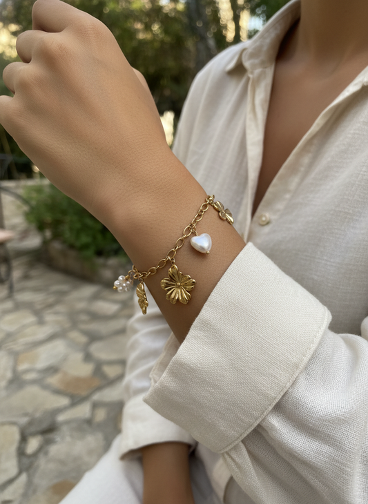 Bracelet doré à charms floraux et cœur en perle