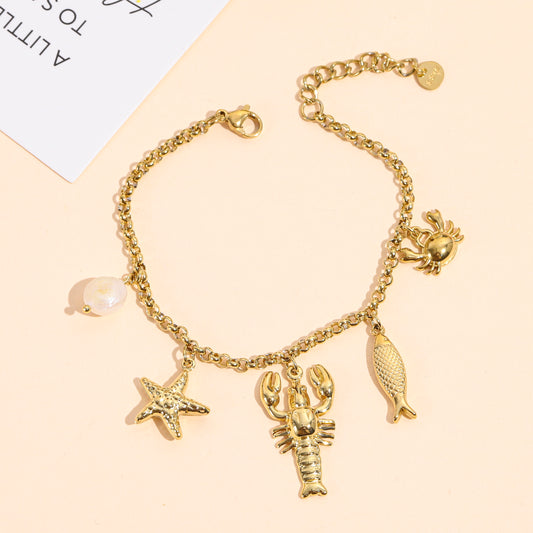 Bracelet doré charms homard, crabe et poisson
