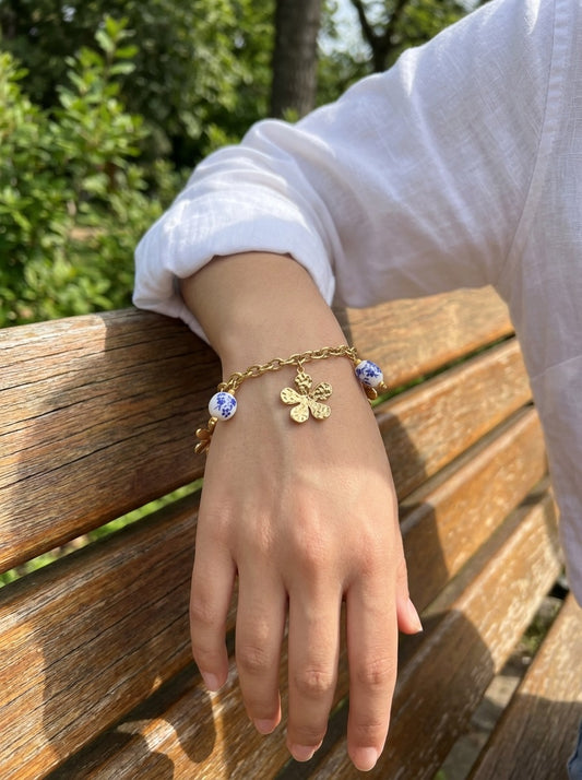 Bracelet doré à fleur martelée et billes en porcelaine