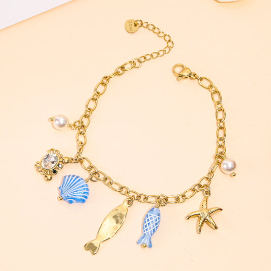 Bracelet doré charms marins bleus et crabe en strass