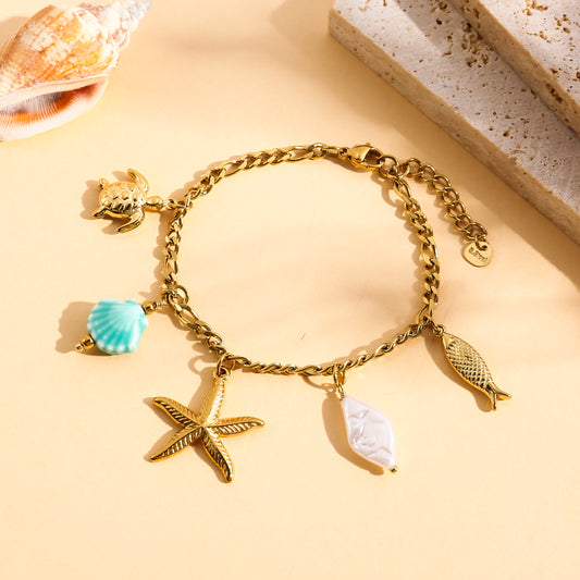 Bracelet doré à charms marins détail coquillage bleu et perle