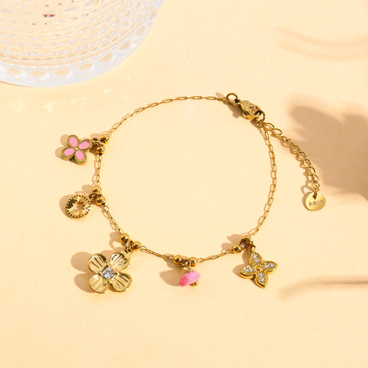 Bracelet doré charms trèfle serti et mini fleur