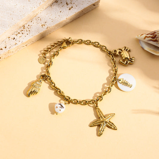 Bracelet doré charms étoile de mer, crabe et coquillage