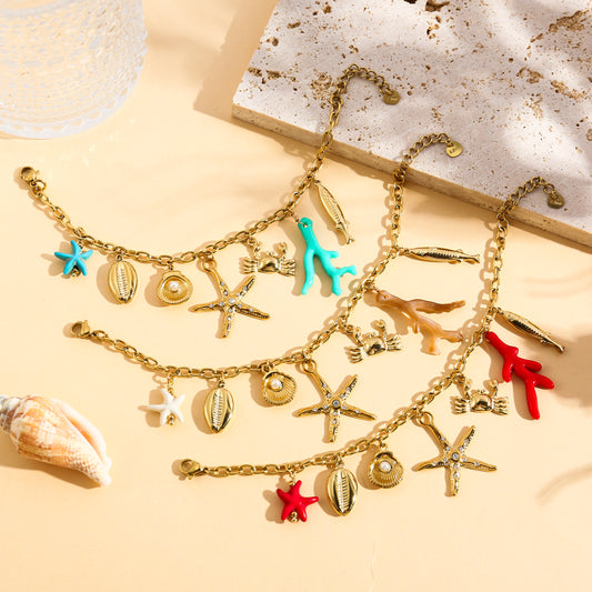 Bracelet doré charms marins, corail et étoile