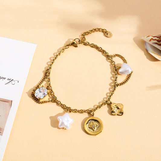 Bracelet doré à breloques étoile, cœur et fleur