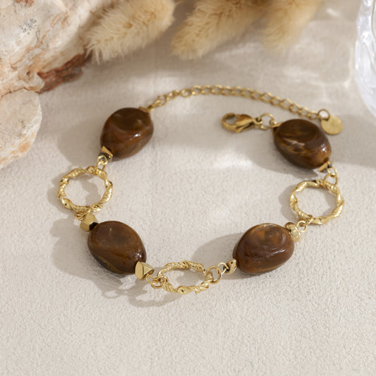 Bracelet anneaux torsadés perles résine