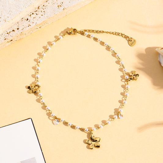 Chaîne de cheville dorée perlée pendante fleurs et strass
