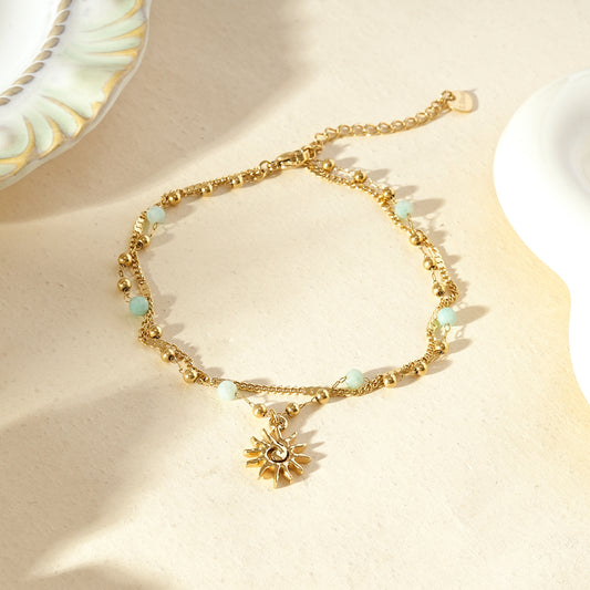 Chaîne de cheville dorée double rang soleil et perles bleu