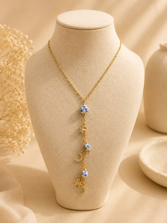 Collier doré avec breloques porcelaine bleu et constellation