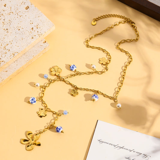 Collier doré en Y à charms fleurs et perles en céramique