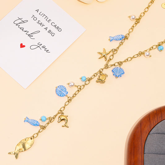 Collier doré en Y charms marins bleus et pendentif poisson