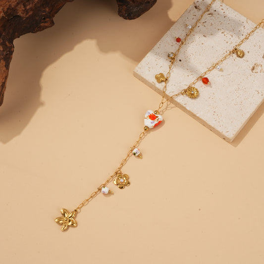 Collier doré en Y à perles porcelaine fleurie et charms fleurs