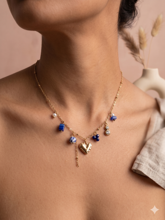 Collier doré à breloques bleues et cœur central