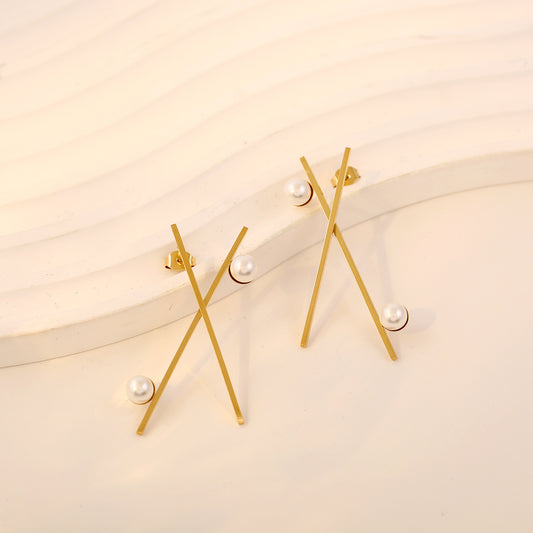 Boucles d'oreilles dorées lignes croisées avec perles