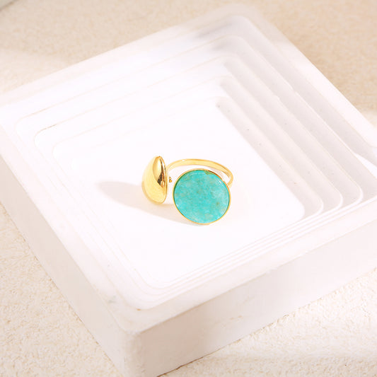 Bague dorée ouverture devant goutte avec pierre ronde bleue