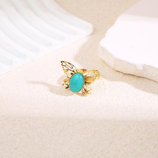 Bague dorée papillon pierre bleue