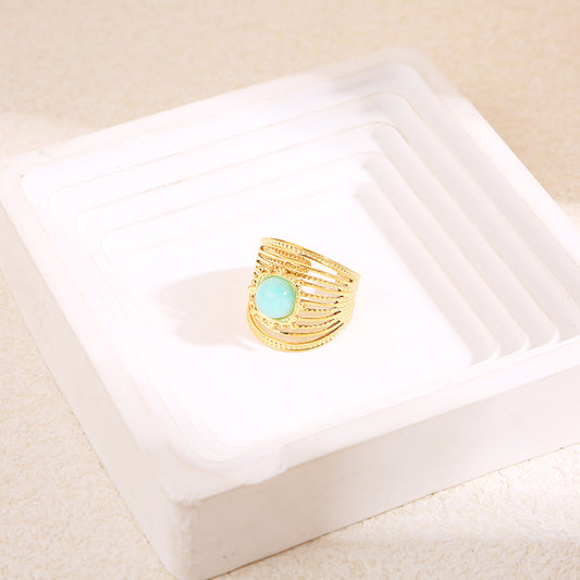 Bague dorée multi lignes pierre ronde bleue
