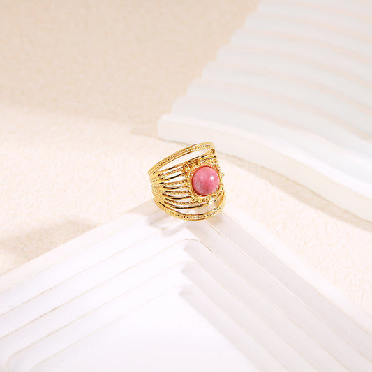 Bague dorée multi anneaux texturés avec pierre centrale