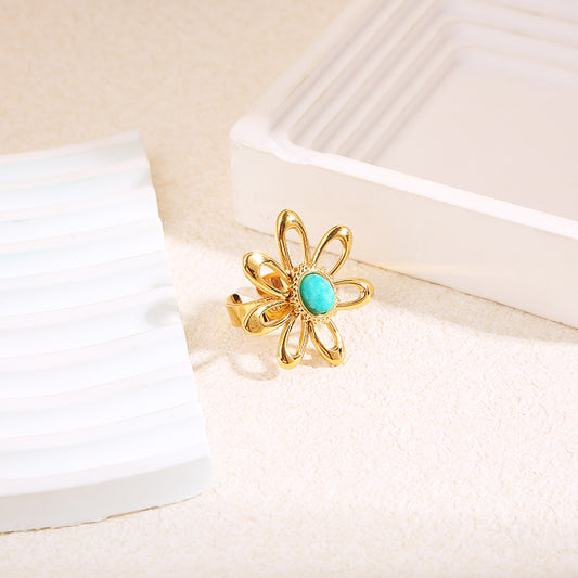 Bague dorée grande fleur pierre bleue
