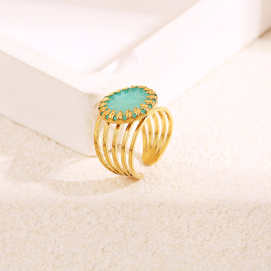 Bague dorée multi ligne griffe pierre bleue