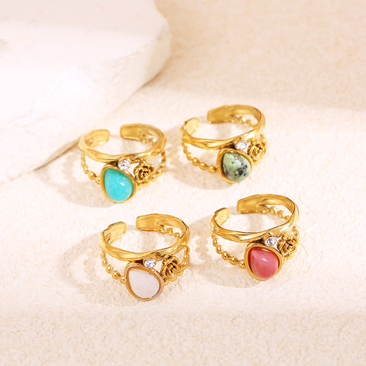 Bague dorée fleur strass et pierre goutte bleue