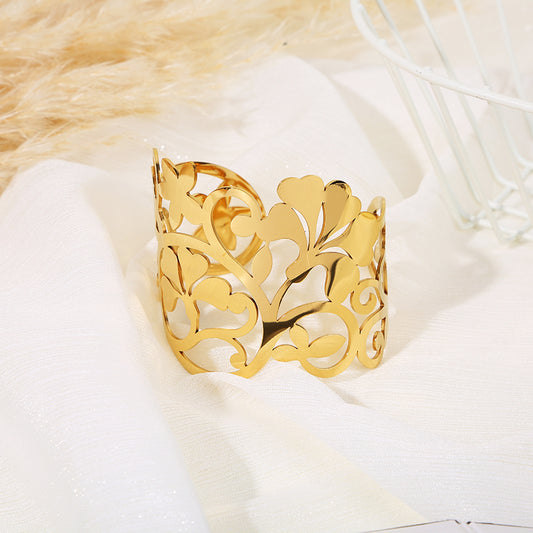 Bracelet manchette doré ajouré motif grandes feuilles et pétales stylisés