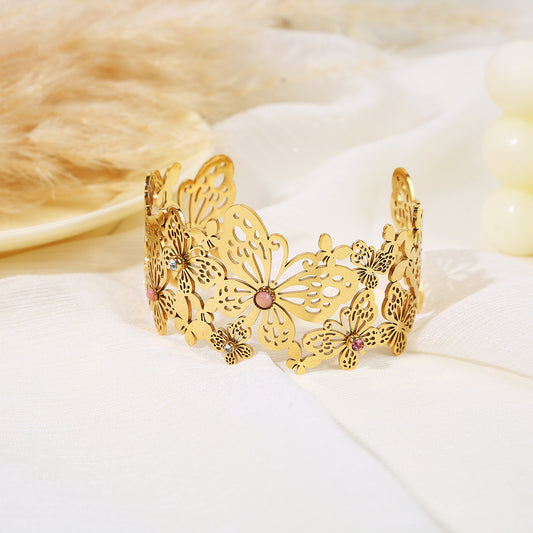 Bracelet manchette doré ajouré papillons et strass colorés