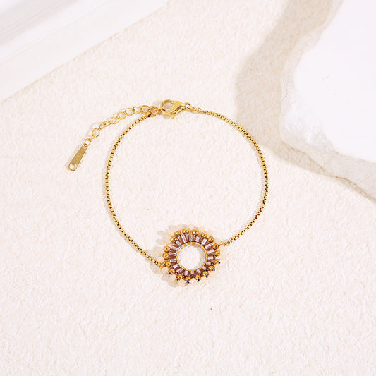 Bracelet chaîne dorée fine avec pendentif rond perlé