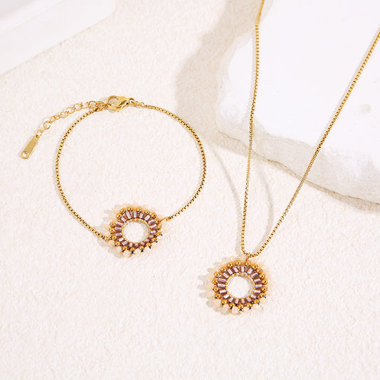 Bracelet chaîne dorée fine avec pendentif rond perlé