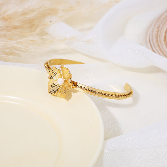 Bracelet jonc doré orné d’une fleur sculptée avec cœur perlé et tige à billes en relief