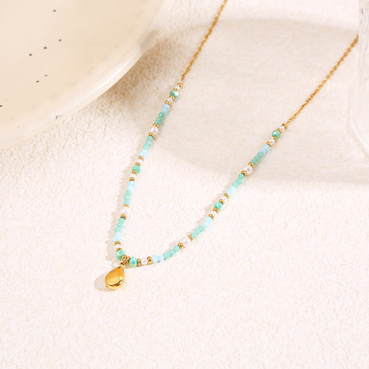 Collier doré cristaux bleus pendentif goutte