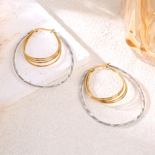 Boucles d'oreilles bicolores à anneaux ovales reliés texturés