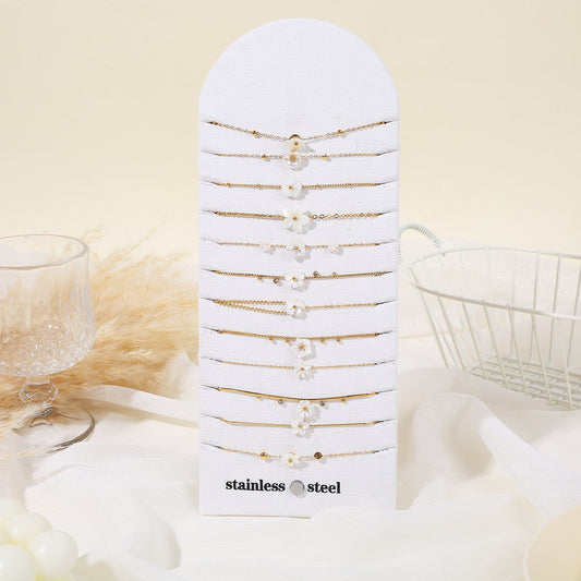 Lot de 12 bracelets chaînes dorées avec fleurs nacre