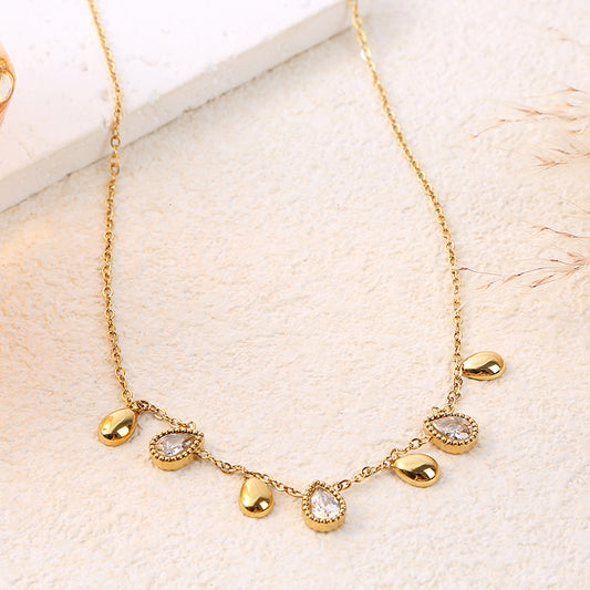 Collier chaîne dorée orné de 7 gouttes dorées et strassées